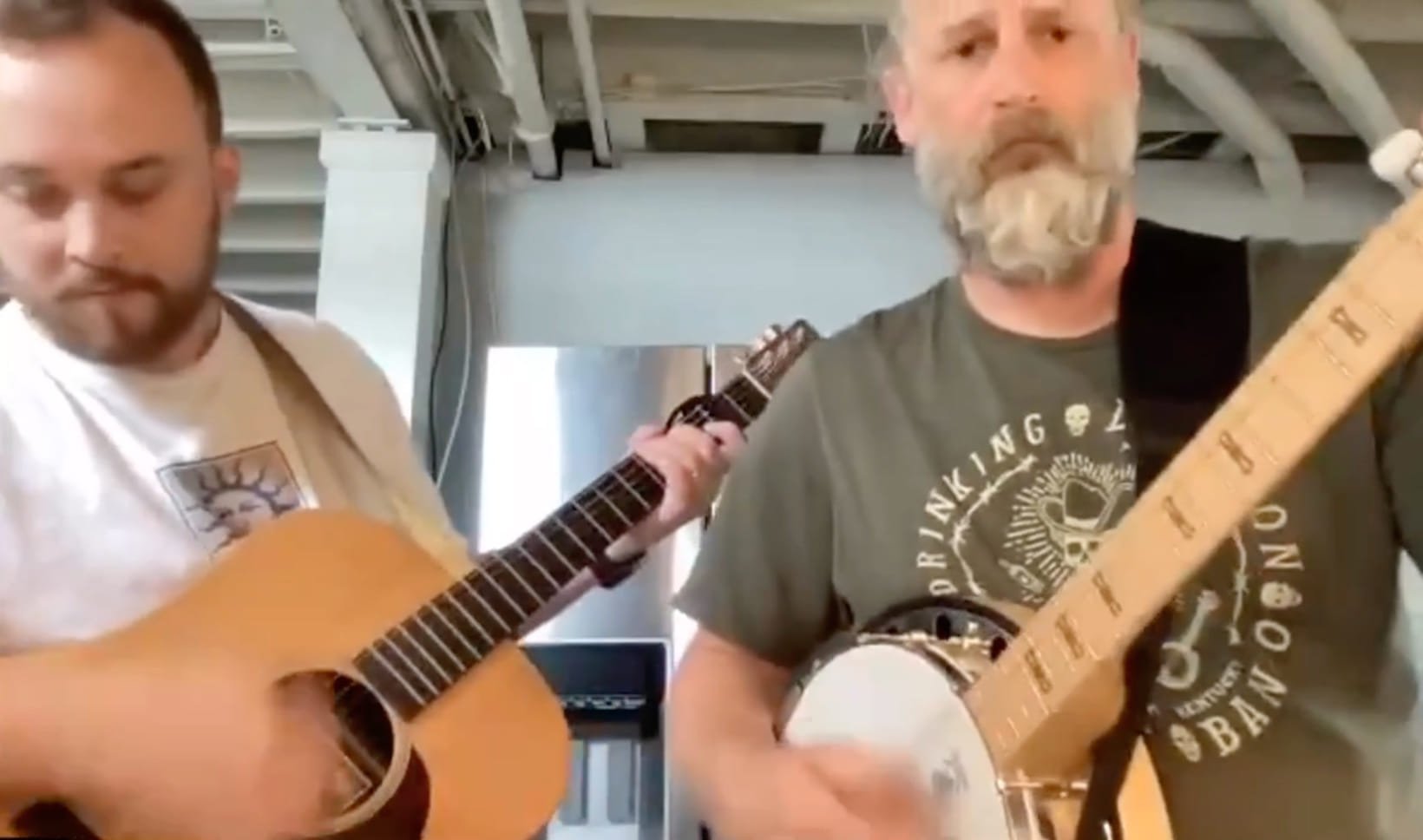 Two Ample team members on a video call playing guitar and banjo