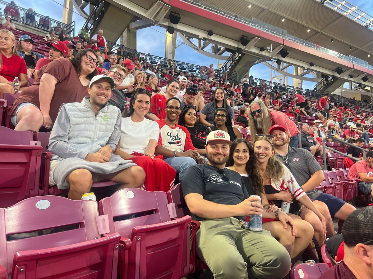 The Ample team together in the stands at a Reds game